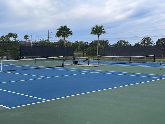 view of tennis court featuring fence