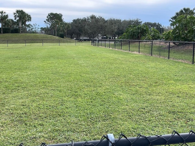 view of yard featuring a rural view and fence