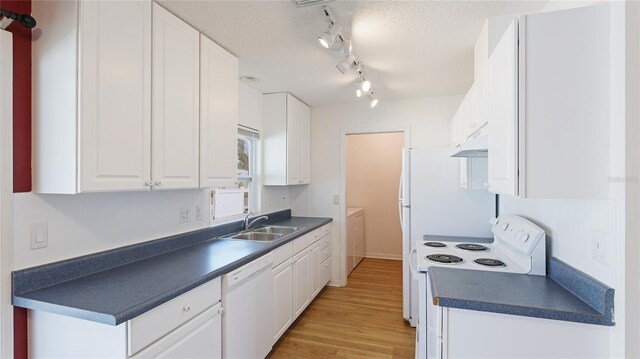 kitchen with a textured ceiling, white appliances, a sink, white cabinetry, and dark countertops