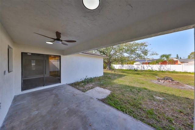 view of yard featuring a ceiling fan, fence, and a patio