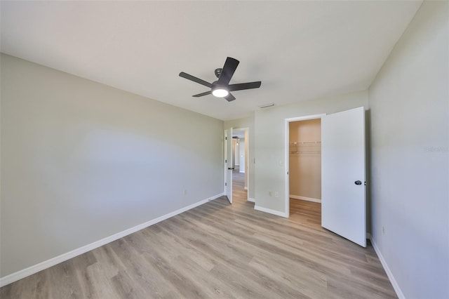 unfurnished bedroom with light wood-type flooring, visible vents, baseboards, and a closet