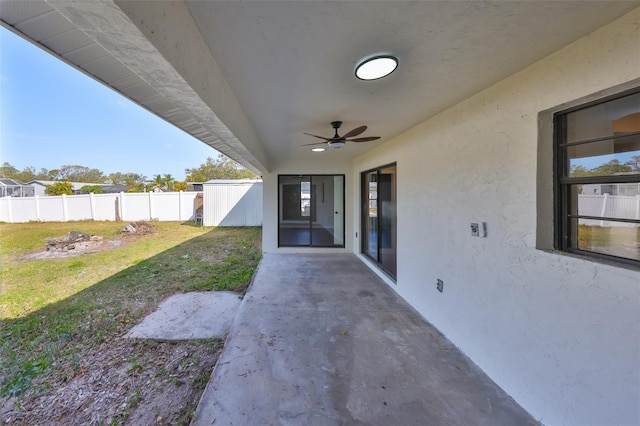 view of patio featuring a ceiling fan and fence