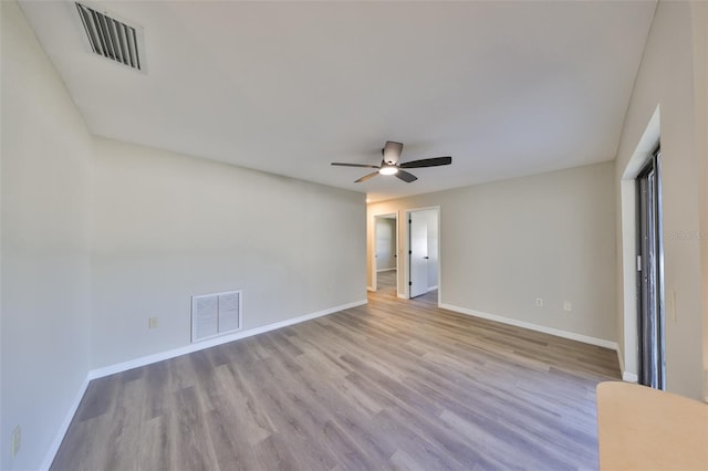 unfurnished bedroom featuring baseboards, visible vents, and wood finished floors