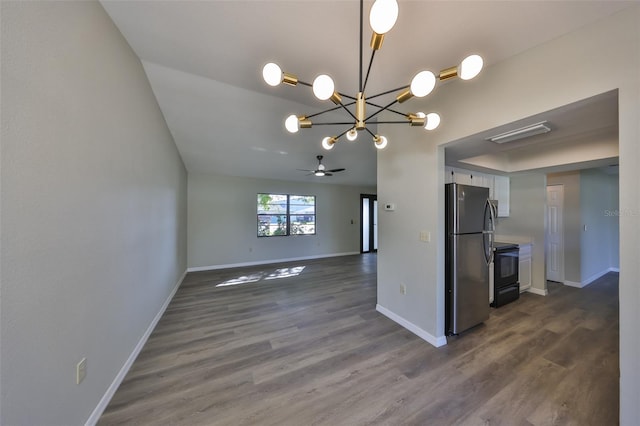 kitchen featuring baseboards, white cabinets, dark wood finished floors, freestanding refrigerator, and black range with electric cooktop