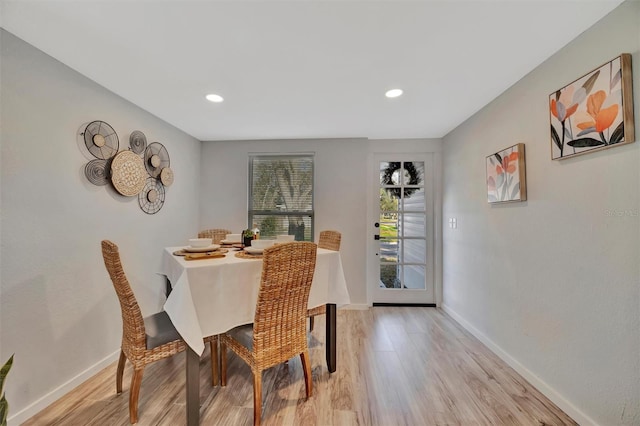 dining room featuring baseboards, recessed lighting, and light wood-style floors