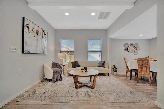 sitting room with light wood-style flooring, recessed lighting, visible vents, and baseboards