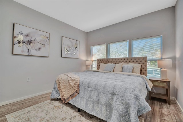 bedroom featuring baseboards and wood finished floors