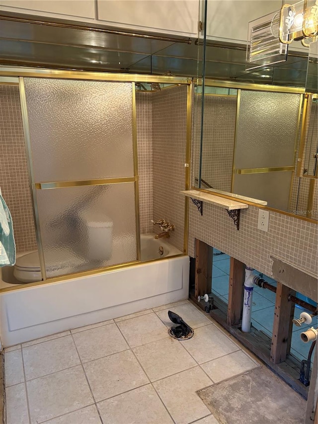 bathroom featuring combined bath / shower with glass door and tile patterned floors