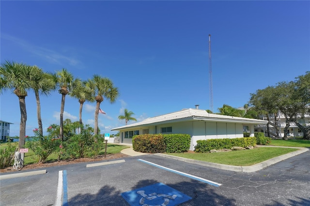 view of building exterior with uncovered parking