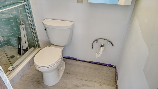 bathroom featuring a shower stall and toilet