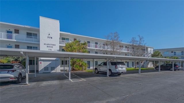 view of building exterior featuring covered parking