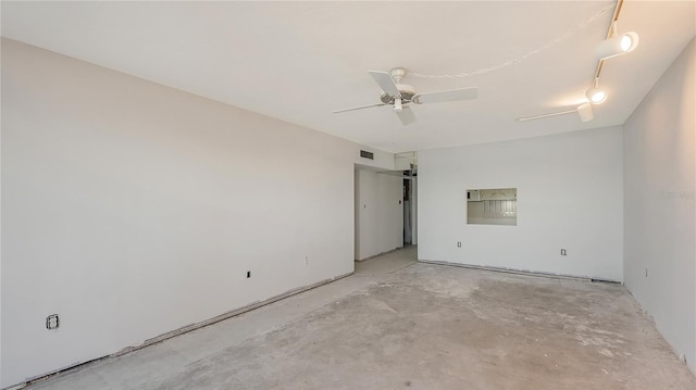 empty room with ceiling fan and concrete flooring