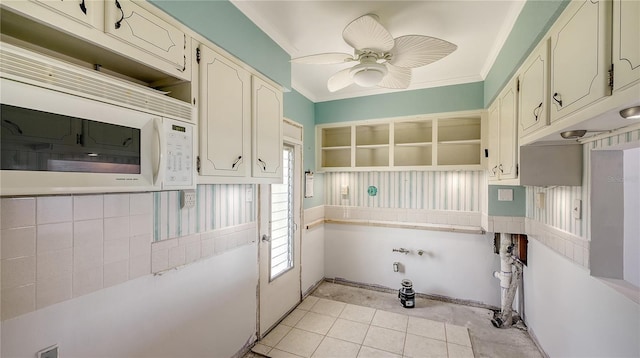 laundry area featuring a healthy amount of sunlight, crown molding, and a ceiling fan