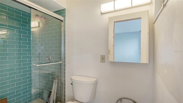 bathroom with toilet and a shower stall