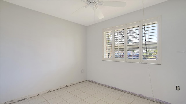 empty room with ceiling fan and a wealth of natural light