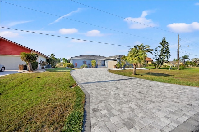 ranch-style house featuring a garage, a front yard, and decorative driveway