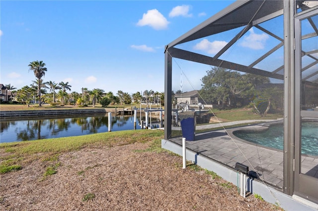 exterior space featuring glass enclosure and a water view