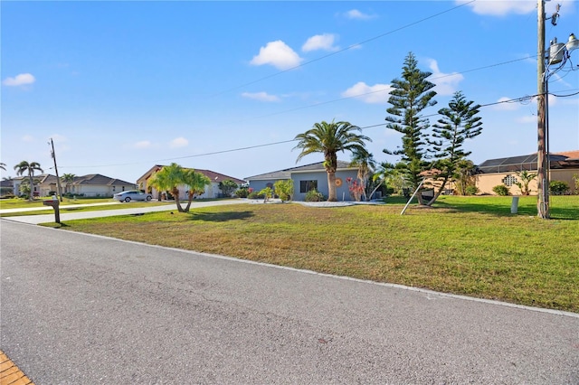 single story home featuring a front lawn and a residential view