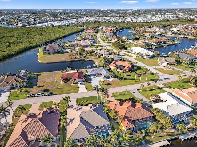 drone / aerial view featuring a water view and a residential view