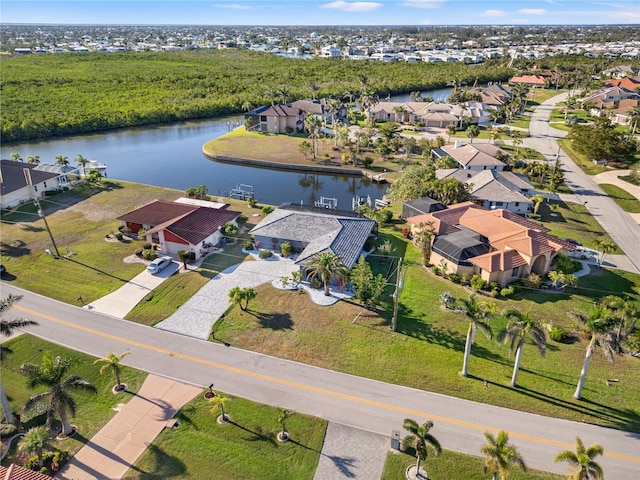 bird's eye view featuring a water view and a residential view