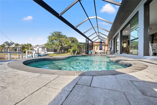 outdoor pool featuring a patio area and a lanai