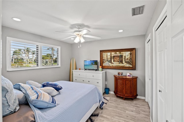 bedroom with light wood finished floors, baseboards, visible vents, and recessed lighting