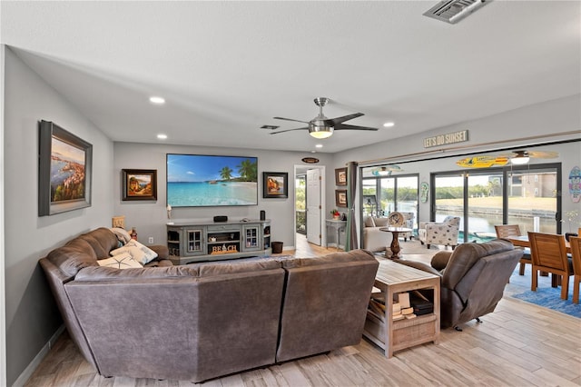 living room with baseboards, visible vents, a ceiling fan, light wood-type flooring, and recessed lighting