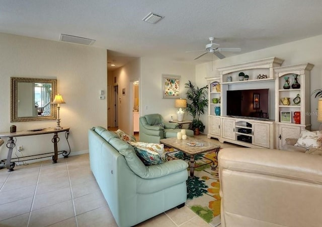 living room with visible vents, ceiling fan, and tile patterned floors