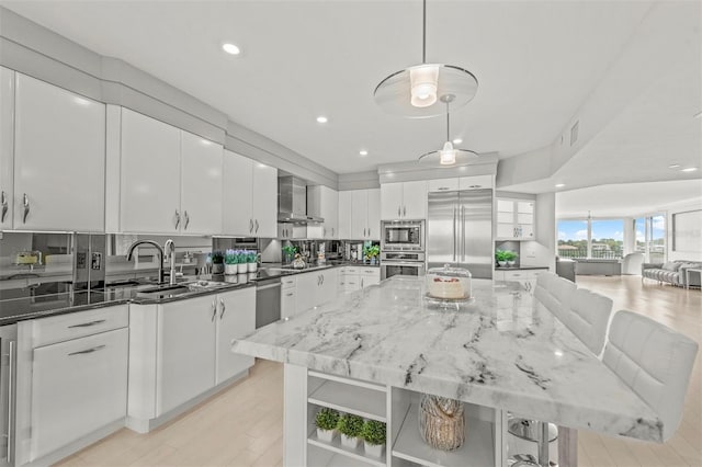 kitchen featuring decorative light fixtures, white cabinetry, open shelves, and built in appliances