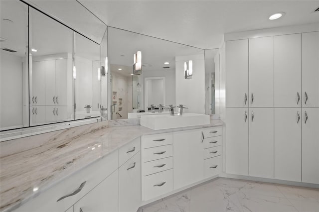 bathroom with marble finish floor, recessed lighting, visible vents, and vanity