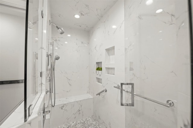 bathroom featuring a marble finish shower