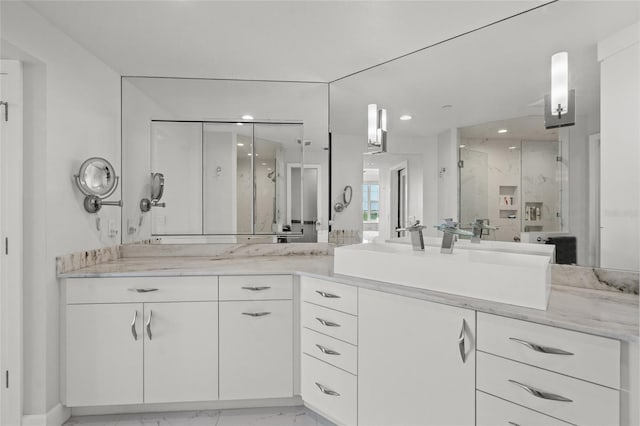 bathroom with recessed lighting, marble finish floor, vanity, and a marble finish shower