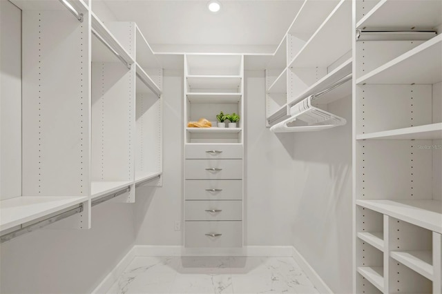 spacious closet featuring marble finish floor