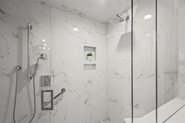 bathroom with a marble finish shower