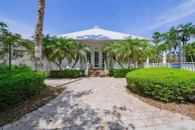 view of front facade with metal roof and fence