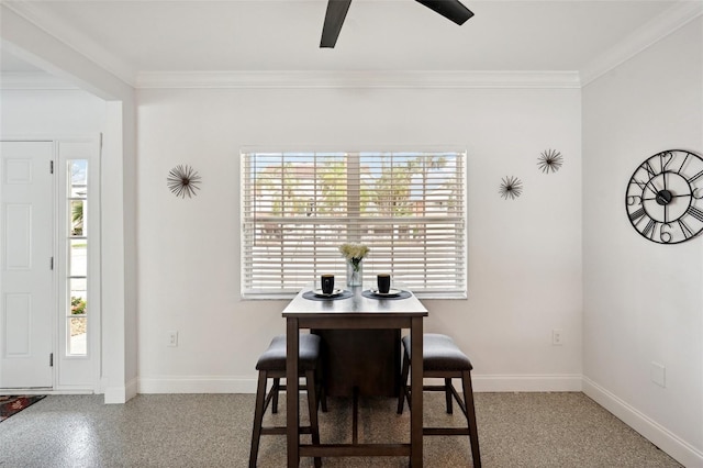 dining space featuring ornamental molding, baseboards, and a ceiling fan