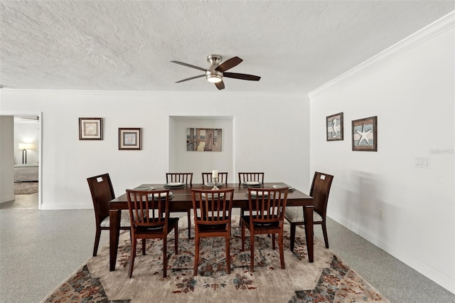 dining area featuring a textured ceiling, ceiling fan, light speckled floor, baseboards, and crown molding