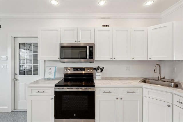 kitchen with white cabinetry, appliances with stainless steel finishes, and a sink