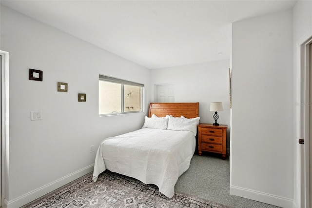 bedroom featuring carpet and baseboards