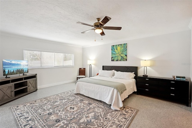 bedroom featuring a textured ceiling, ceiling fan, baseboards, and crown molding