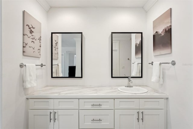 full bathroom with ornamental molding and vanity