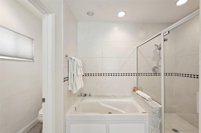 bathroom with toilet, a stall shower, a bath, and recessed lighting