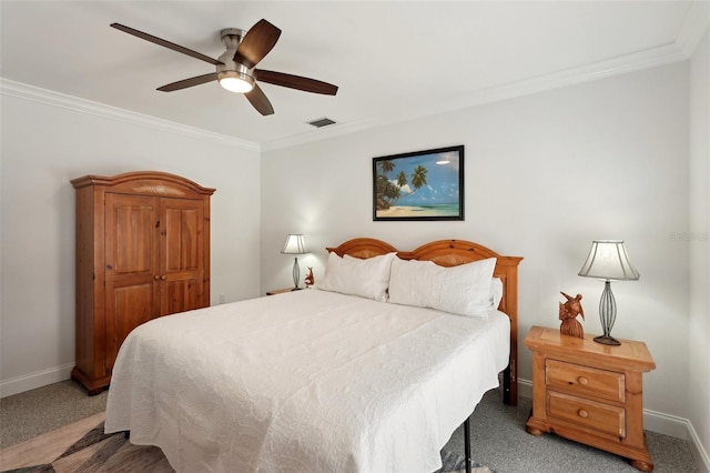 carpeted bedroom with baseboards, visible vents, ceiling fan, and crown molding