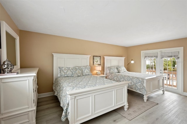 bedroom featuring light wood-style floors, access to outside, french doors, and baseboards