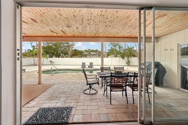 view of patio with a fenced backyard, a fenced in pool, and outdoor dining space