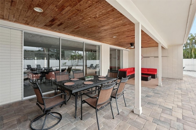 view of patio featuring a ceiling fan, outdoor dining space, and an outdoor living space