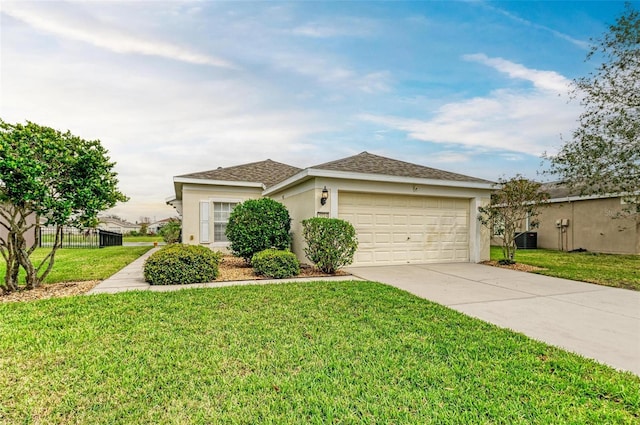 single story home featuring cooling unit, fence, concrete driveway, stucco siding, and a front lawn