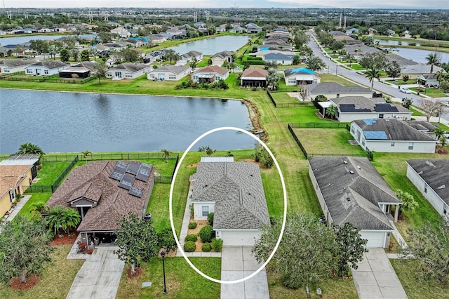 drone / aerial view with a water view and a residential view