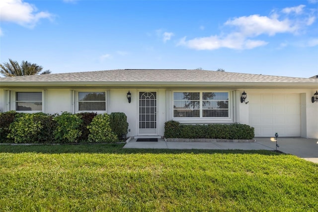 single story home with driveway, a shingled roof, an attached garage, a front lawn, and stucco siding