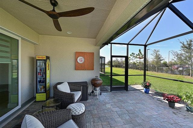 sunroom featuring a ceiling fan